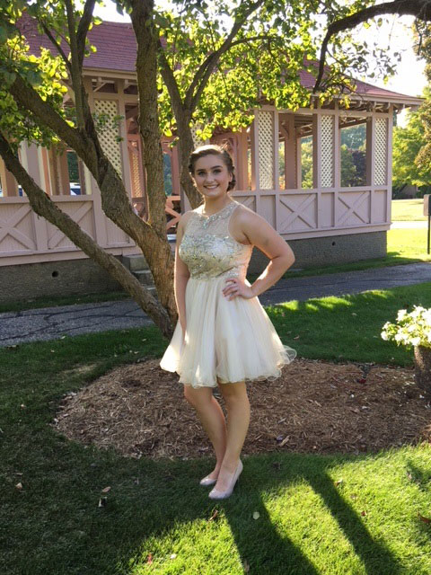 Katie Murphy posing outdoors in formal attire